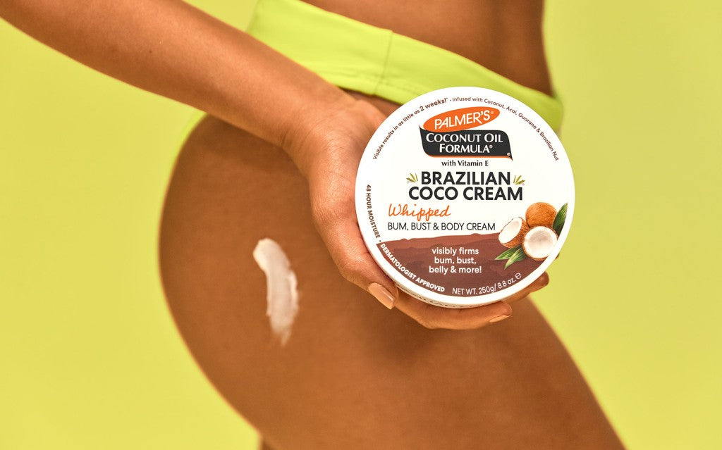 Woman in bikini bottoms holding Palmer's Brazilian Coco Cream, the best way how to reduce cellulite at home