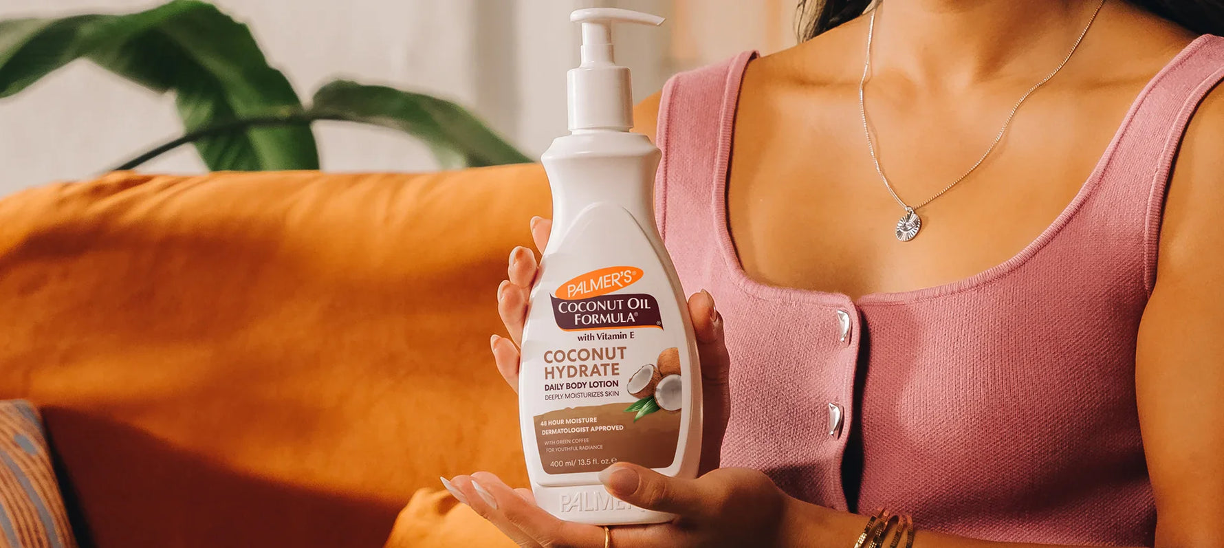 Woman holding Palmer's Coconut Oil Formula Lotion