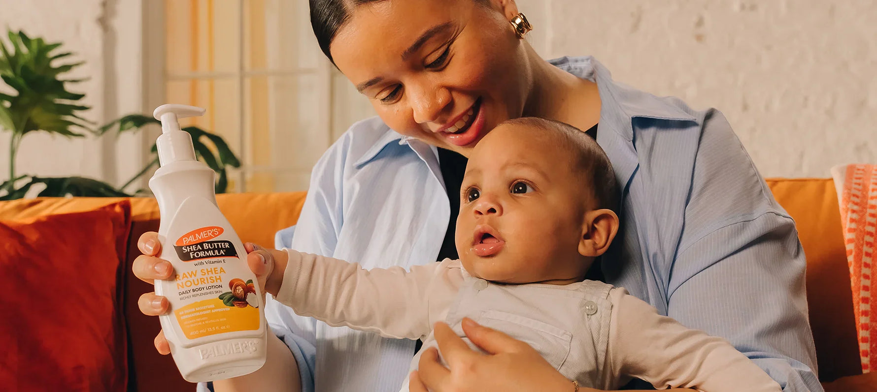 Woman holding baby and Palmer's Shea Butter Formula Body Lotion