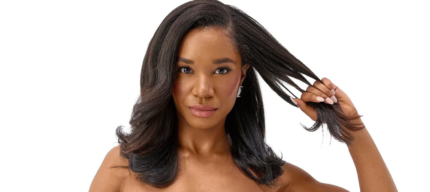 Black woman with straight hair pulling hair out to side to show strength