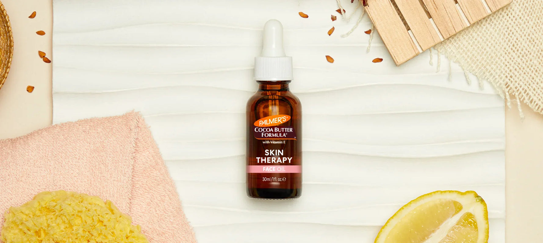 Palmer's Skin Therapy Face Oil on wooden background with ingredients around it