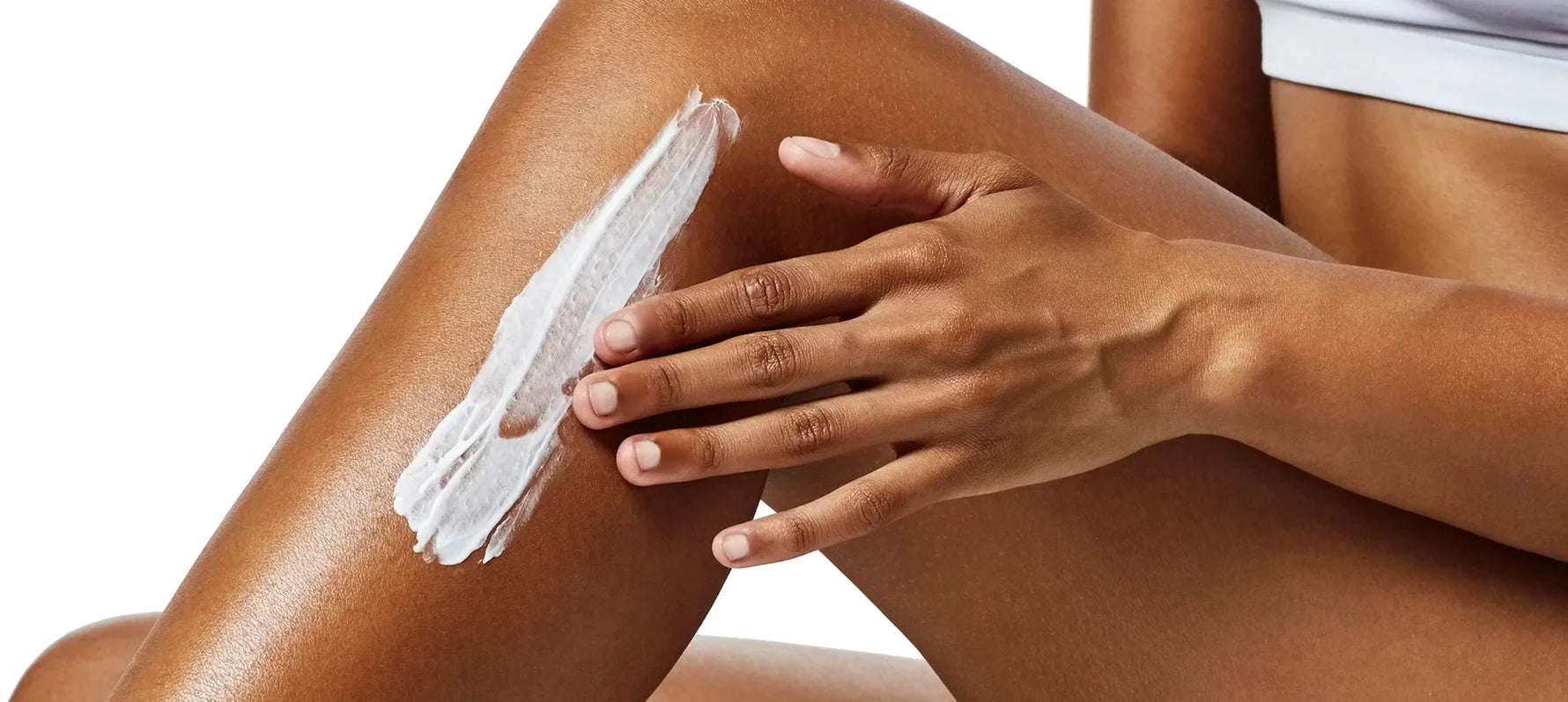 Close up of woman applying lotion to leg