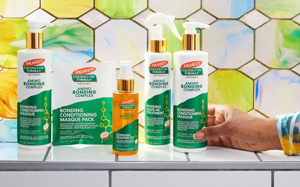 Black woman's hand reaching for Palmer's Amino Bonding Complex Hair Bonding Treatments