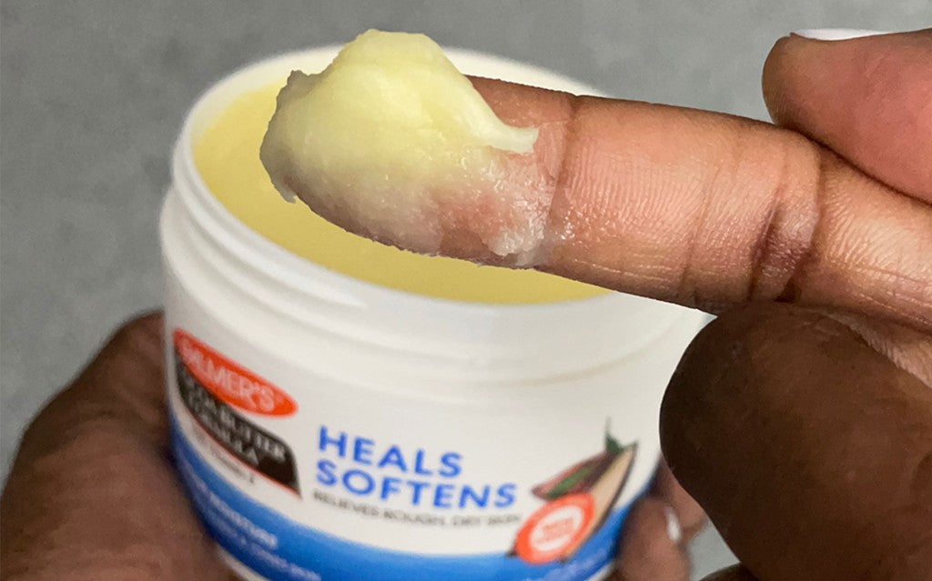 Palmer's Cocoa Butter Formula Original Solid Jar on woman's finger during her skin slugging routine