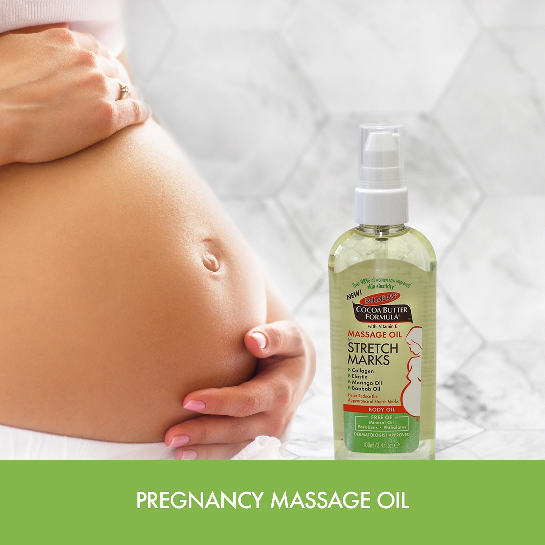 Pregnant belly with hand, Palmer's Massage Oil for Stretch Marks nearby.