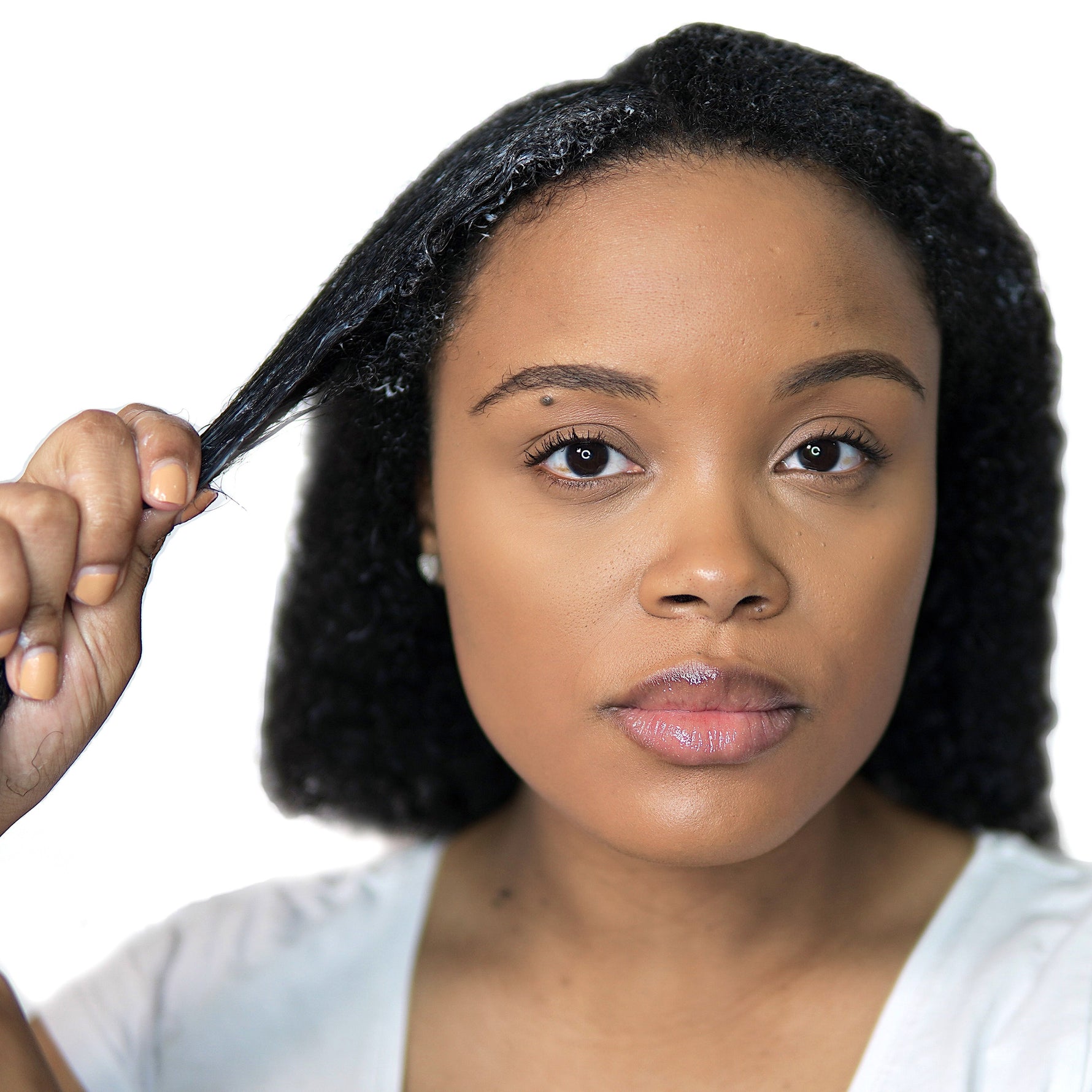 Young person showcasing Moisture Boost Deep Conditioner effects on curly hair.