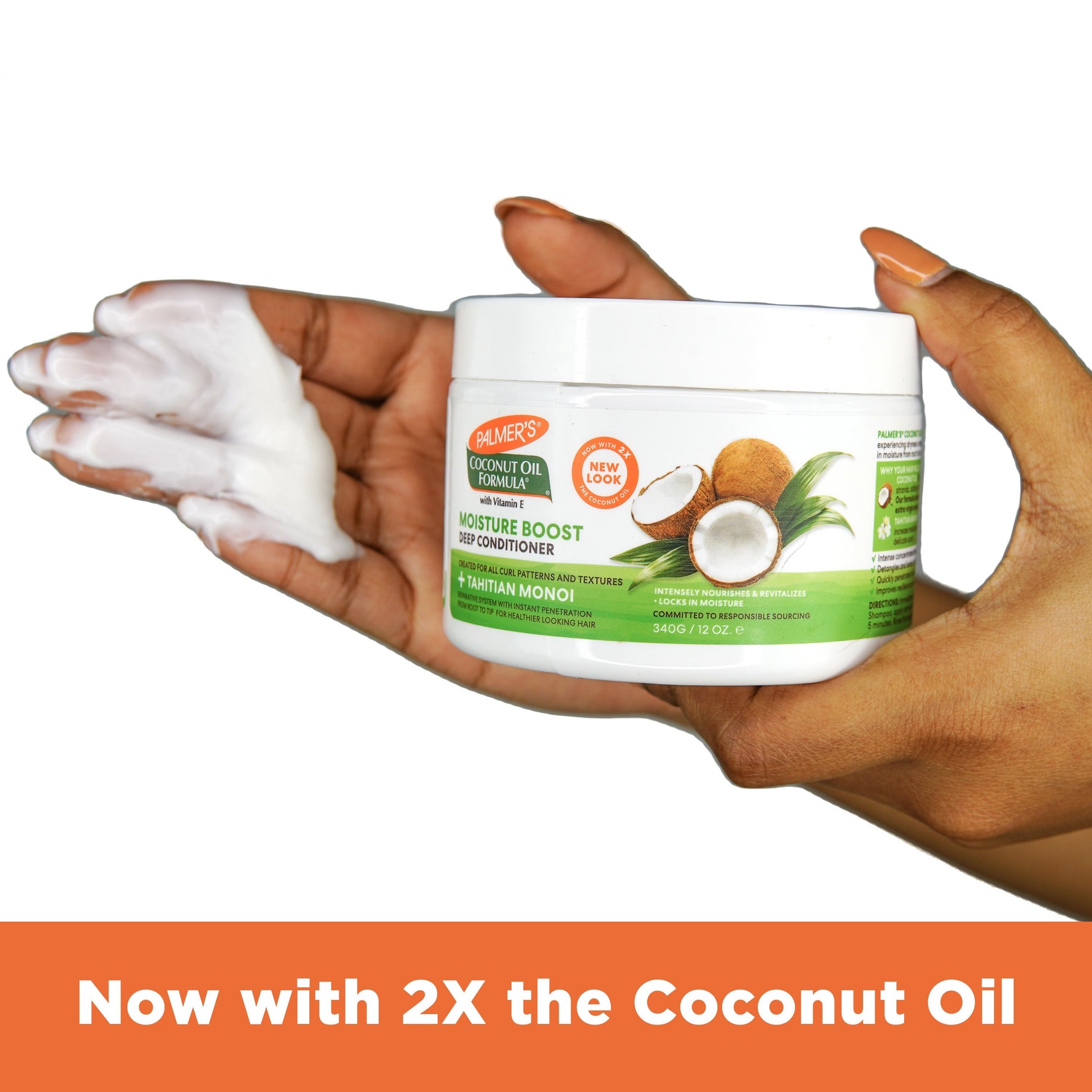 Hands holding Palmer’s Moisture Boost Deep Conditioner with coconut graphics.