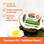Coconut Oil Gro Treatment jar in halved coconut with plumeria flower.