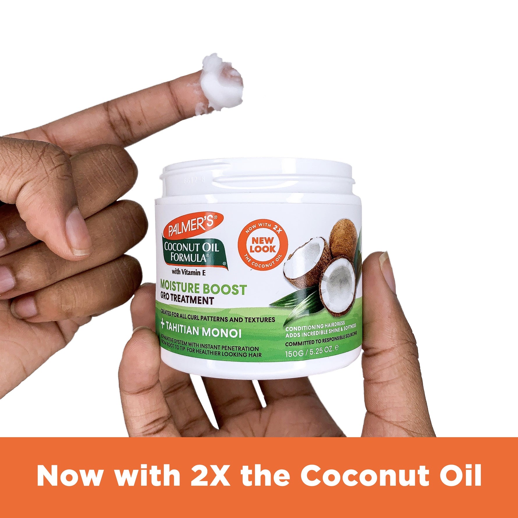 Person holding Palmer's Coconut Oil Gro Treatment jar with cream on fingertip.