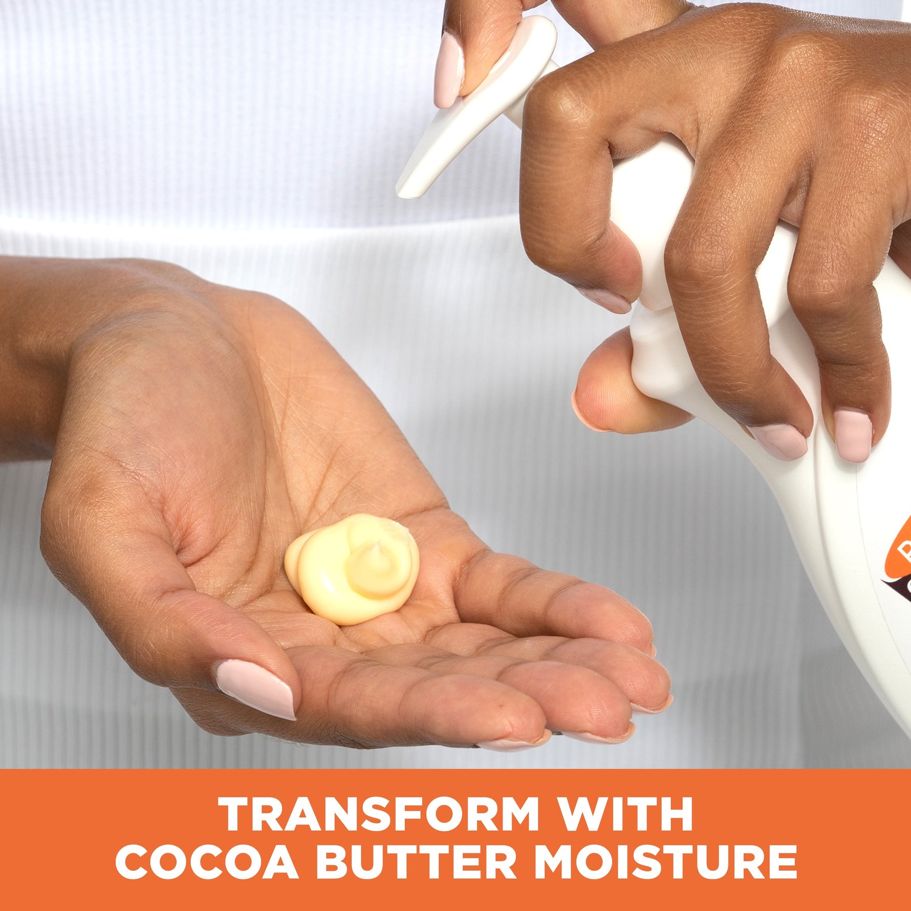 Hands applying Daily Skin Therapy Cocoa Butter Body Lotion.