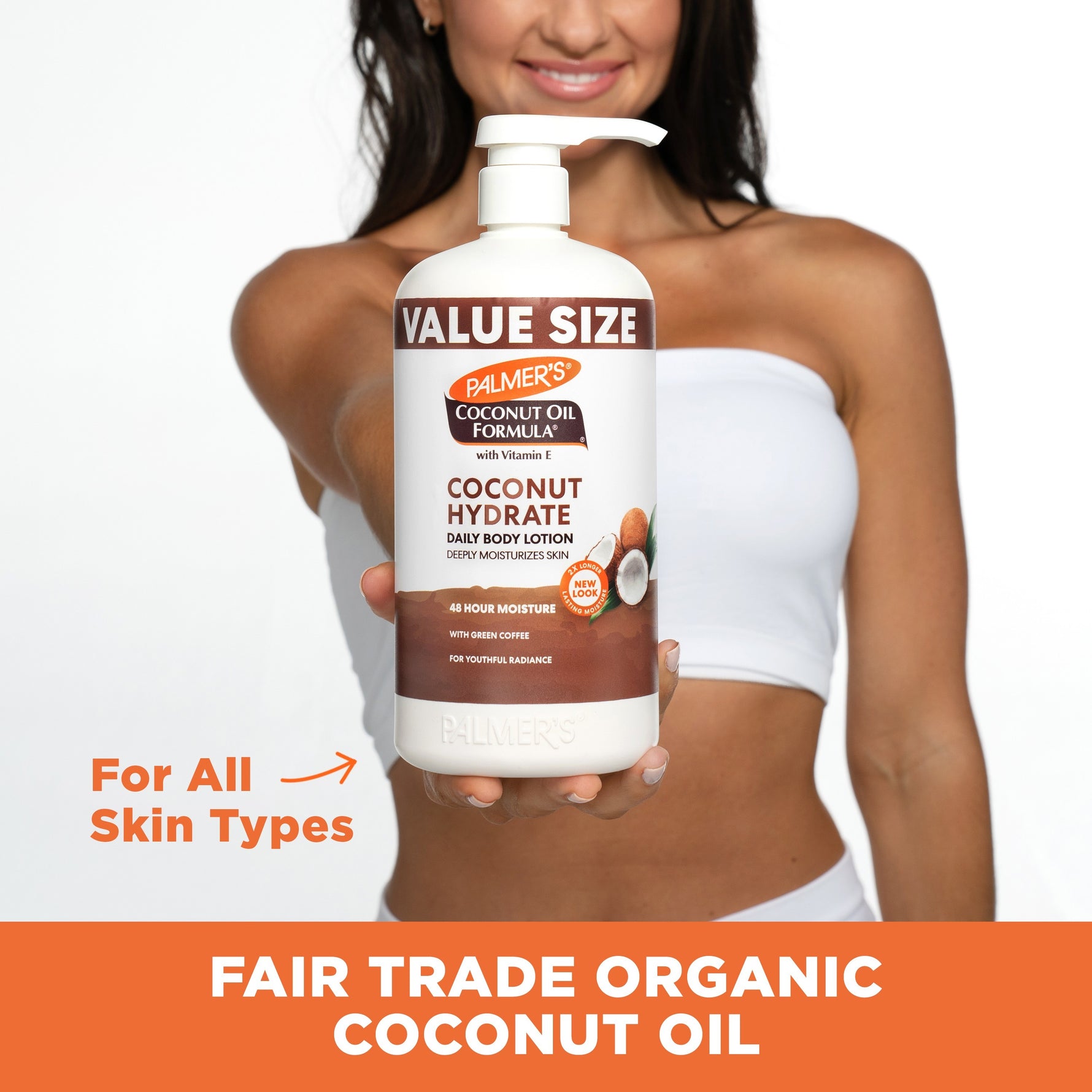Holding Palmer's Coconut Hydrate Body Lotion bottle, label facing forward.