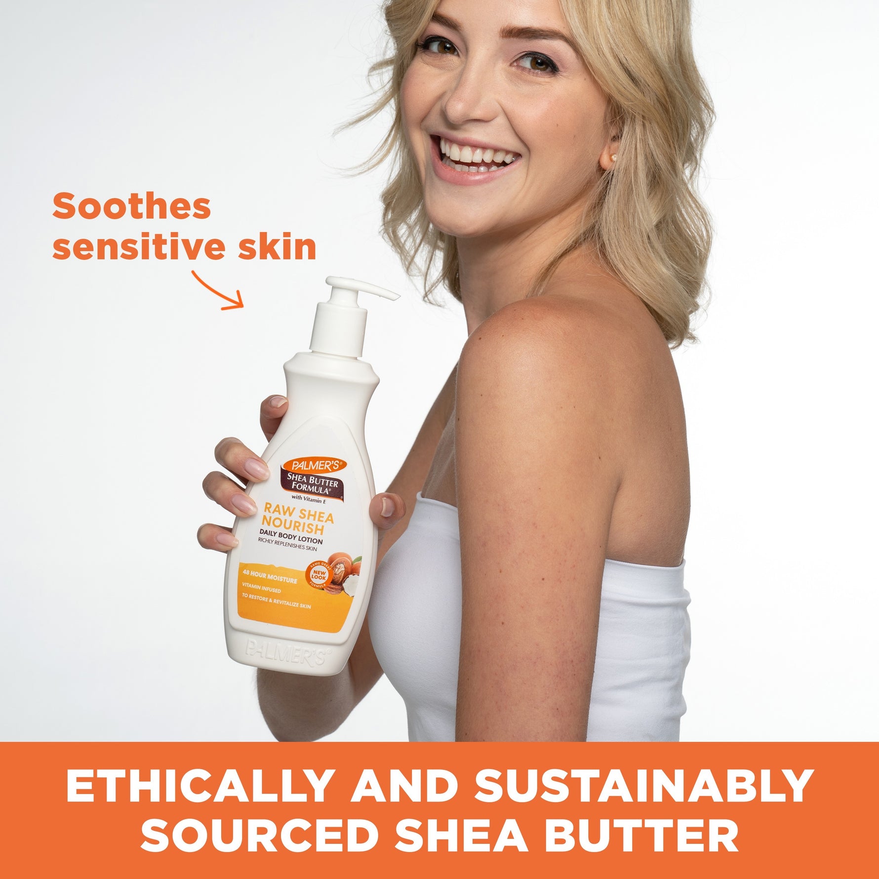 Woman holding Palmer's Raw Shea Nourish Body Lotion pump bottle.