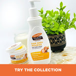 Raw Shea Nourish Body Lotion and Balm with a lit candle.