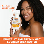 Woman holding Raw Shea Nourish Body Lotion, Soothes sensitive skin.