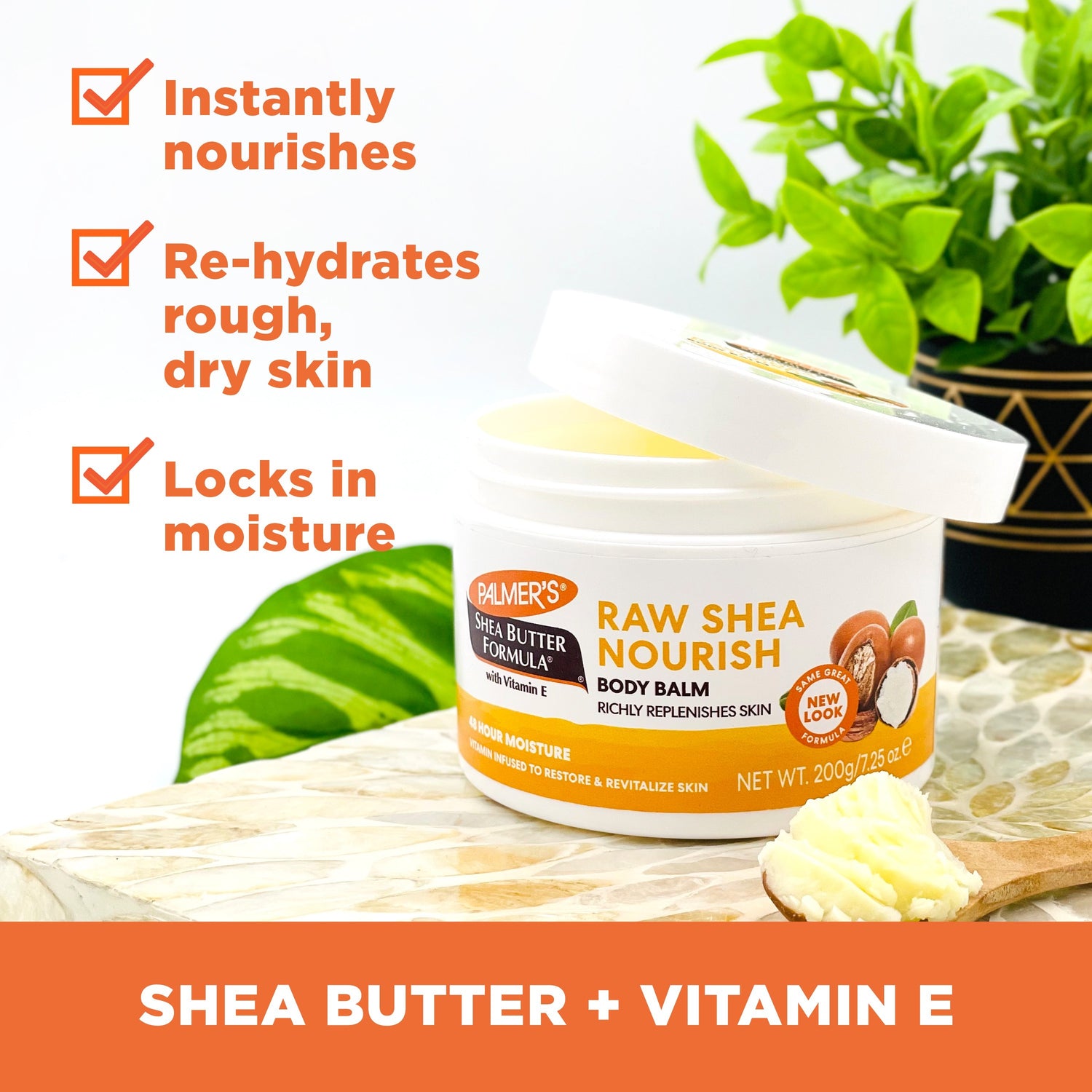 Palmer's Raw Shea Nourish Body Balm with wooden scoop and potted plant.