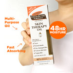 Hand holding Palmer's Cocoa Butter Skin Therapy Oil with Vitamin E box.
