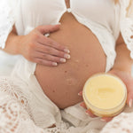 Pregnant woman applies Palmer's Mommy To Be Kit lotion.