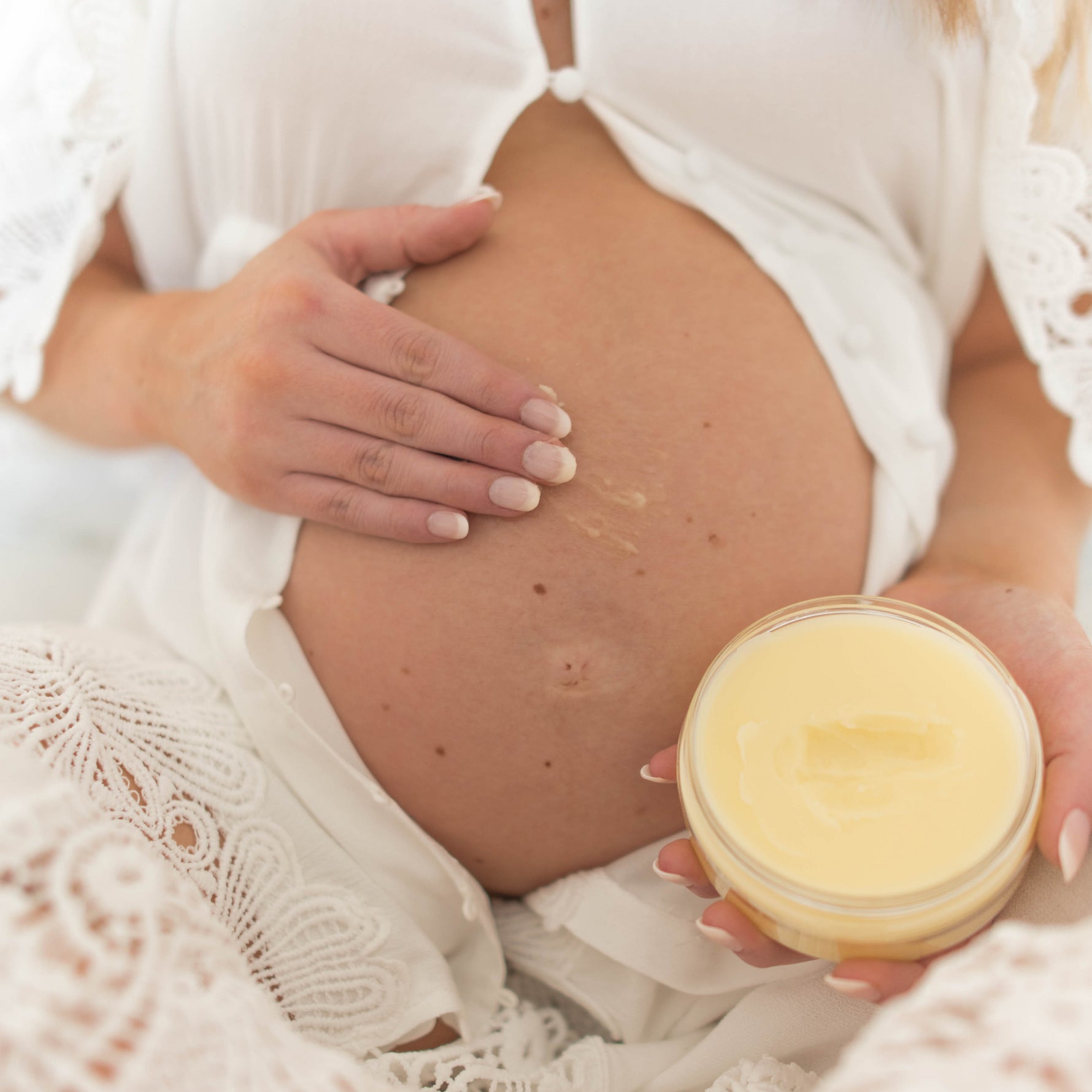 Pregnant woman applies Palmer's Mommy To Be Kit lotion.