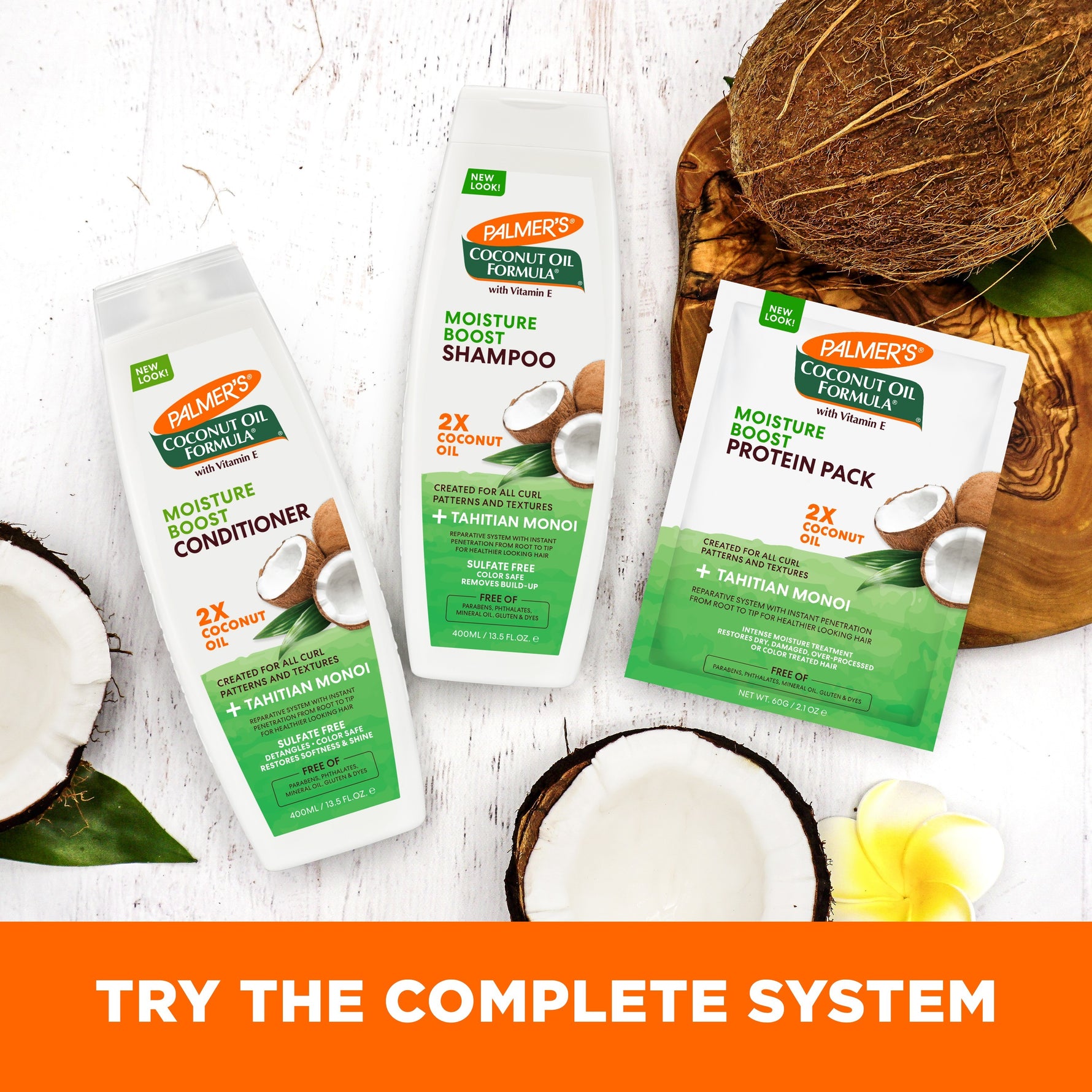 Palmer’s Coconut Oil Protein Pack with shampoo and conditioner, surrounded by coconuts.