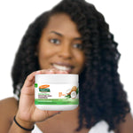 Woman holding Palmer's Coconut Oil Gro Treatment for hair nourishment.