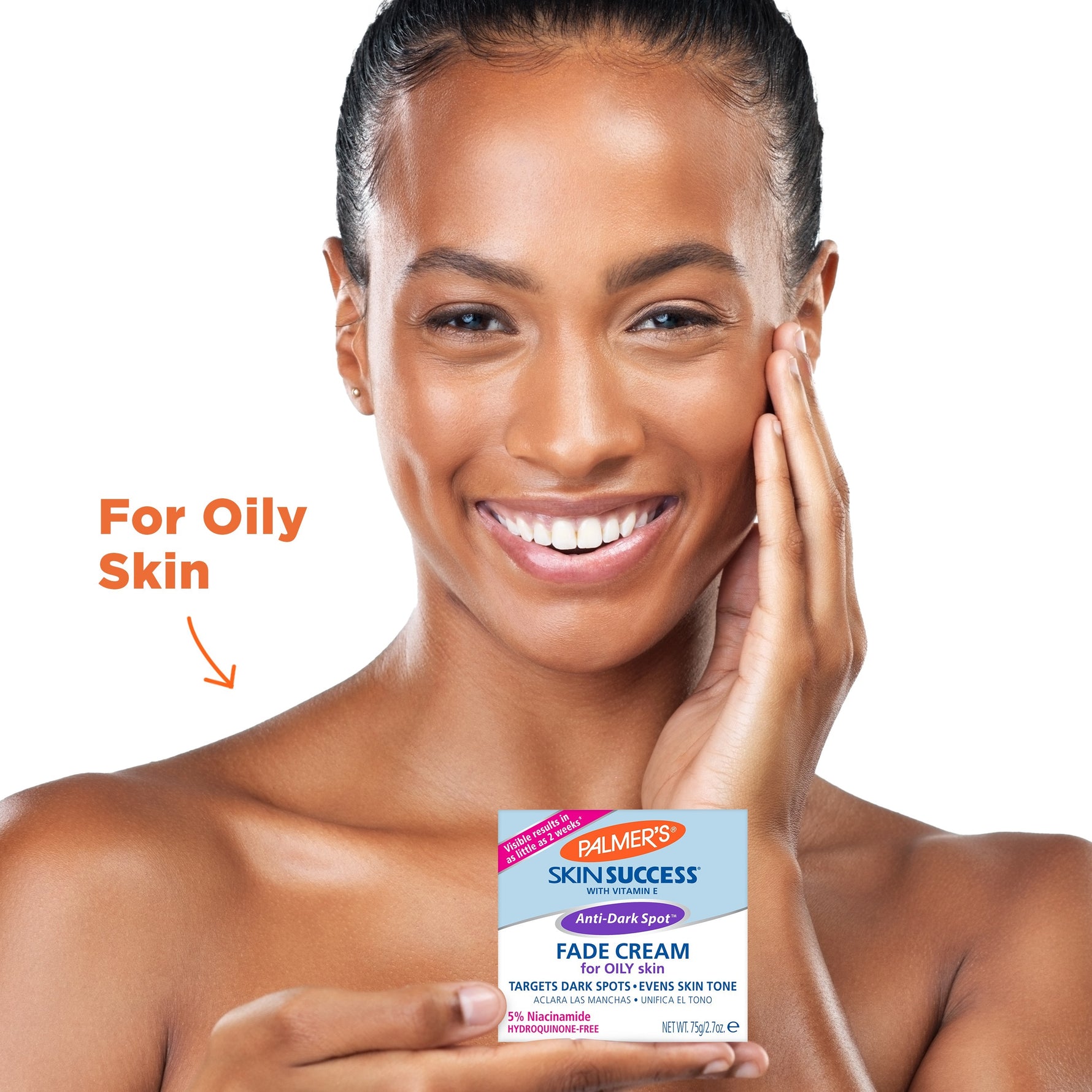 Woman with glowing skin holds Palmer’s Anti-Dark Spot Fade Cream.