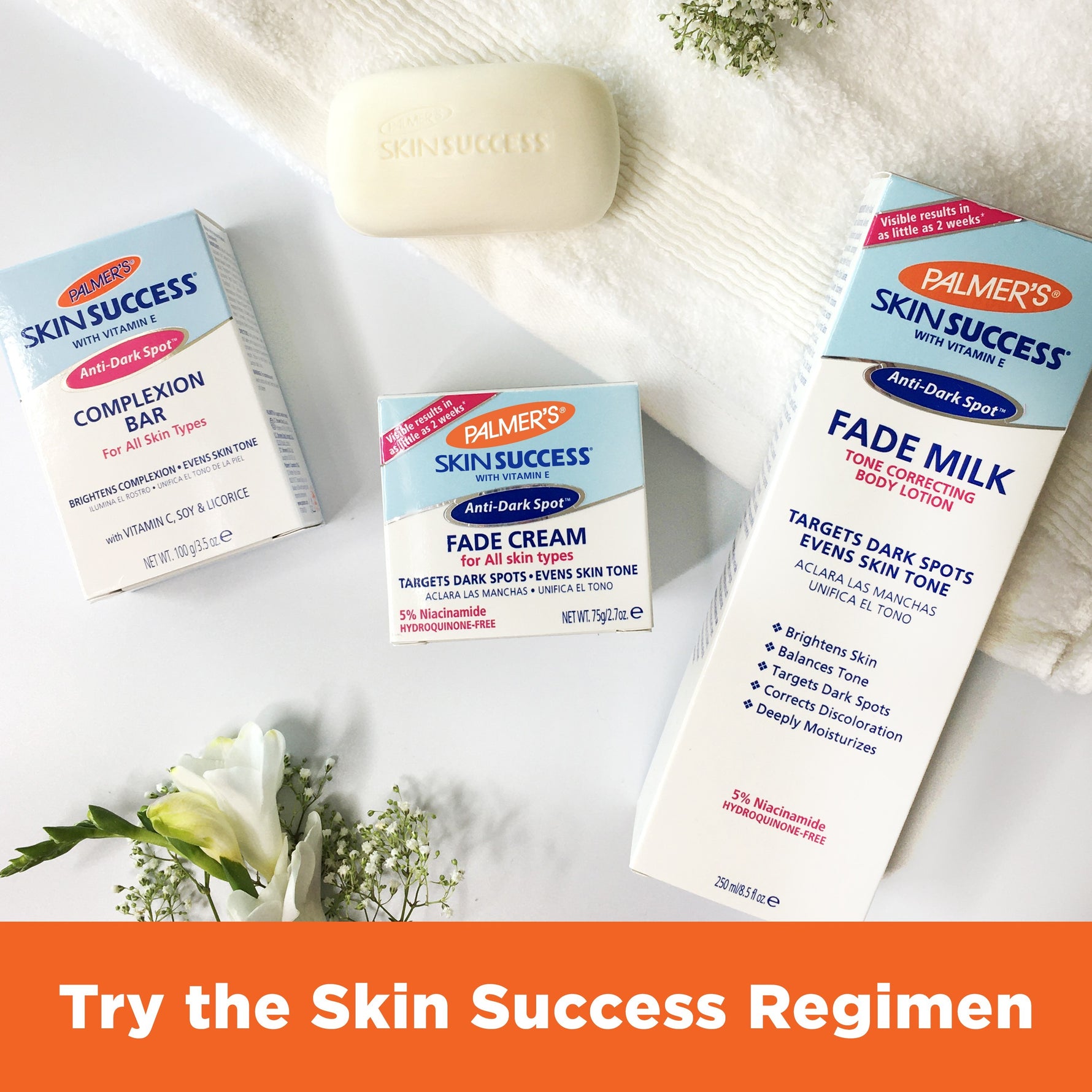 Palmer's anti-dark-spot Skin Success regimen products arranged with decorative flowers.