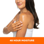 Woman applying Coconut Hydrate Body Oil for 48-hour moisture.