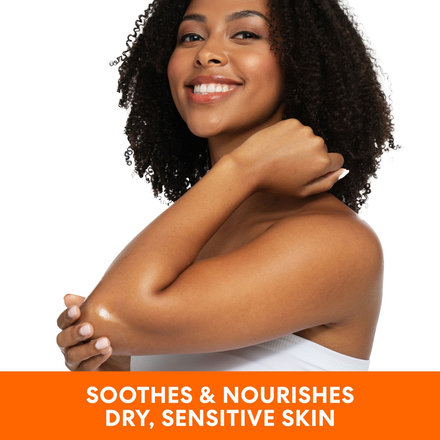 Woman applying Raw Shea Nourish Body Oil to elbow.
