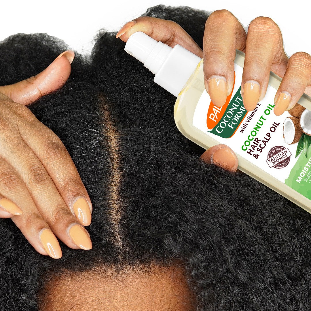 Hands parting hair with Coconut Oil Hair & Scalp Oil spray.