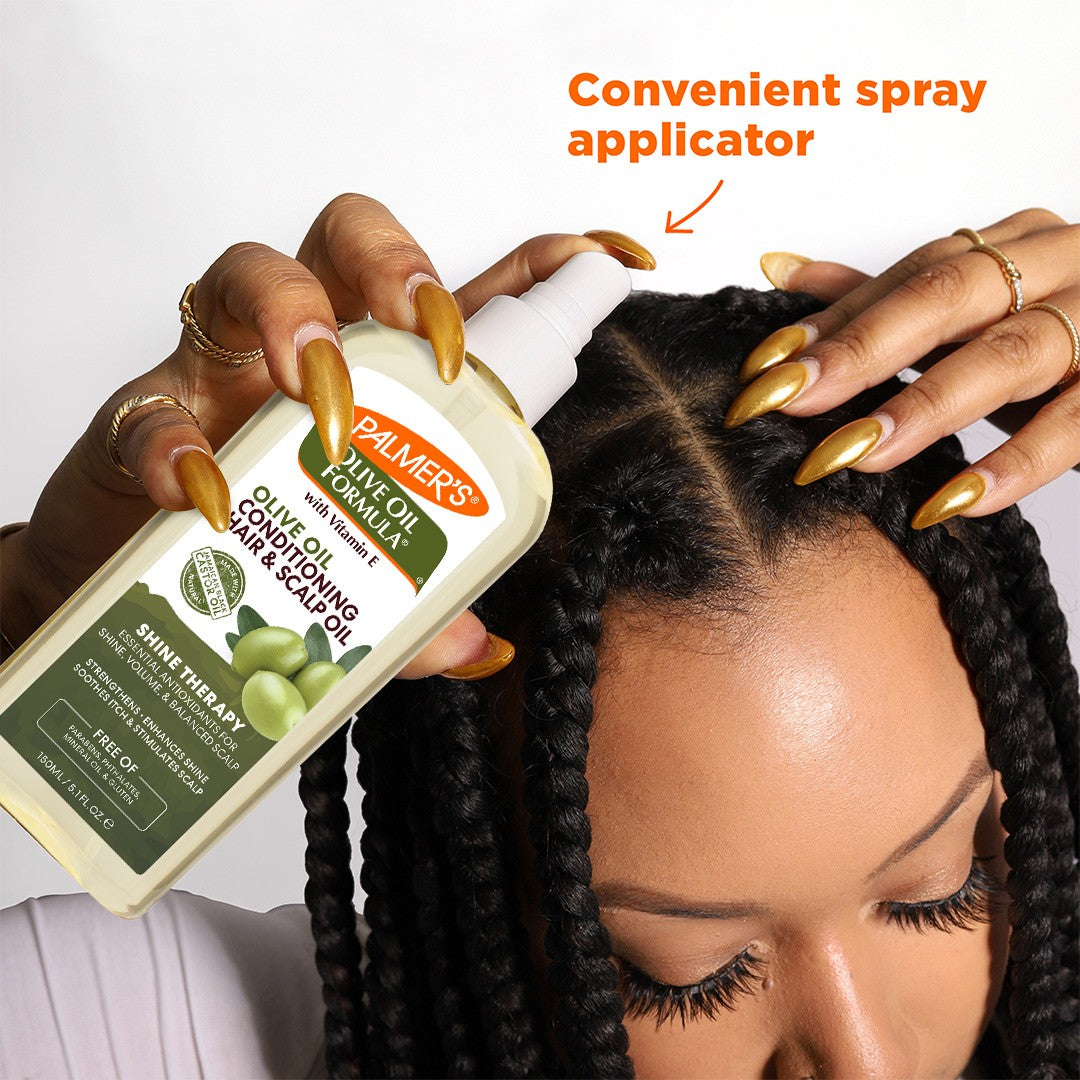 Woman applying Palmer's Olive Oil Hair & Scalp Oil to braids.