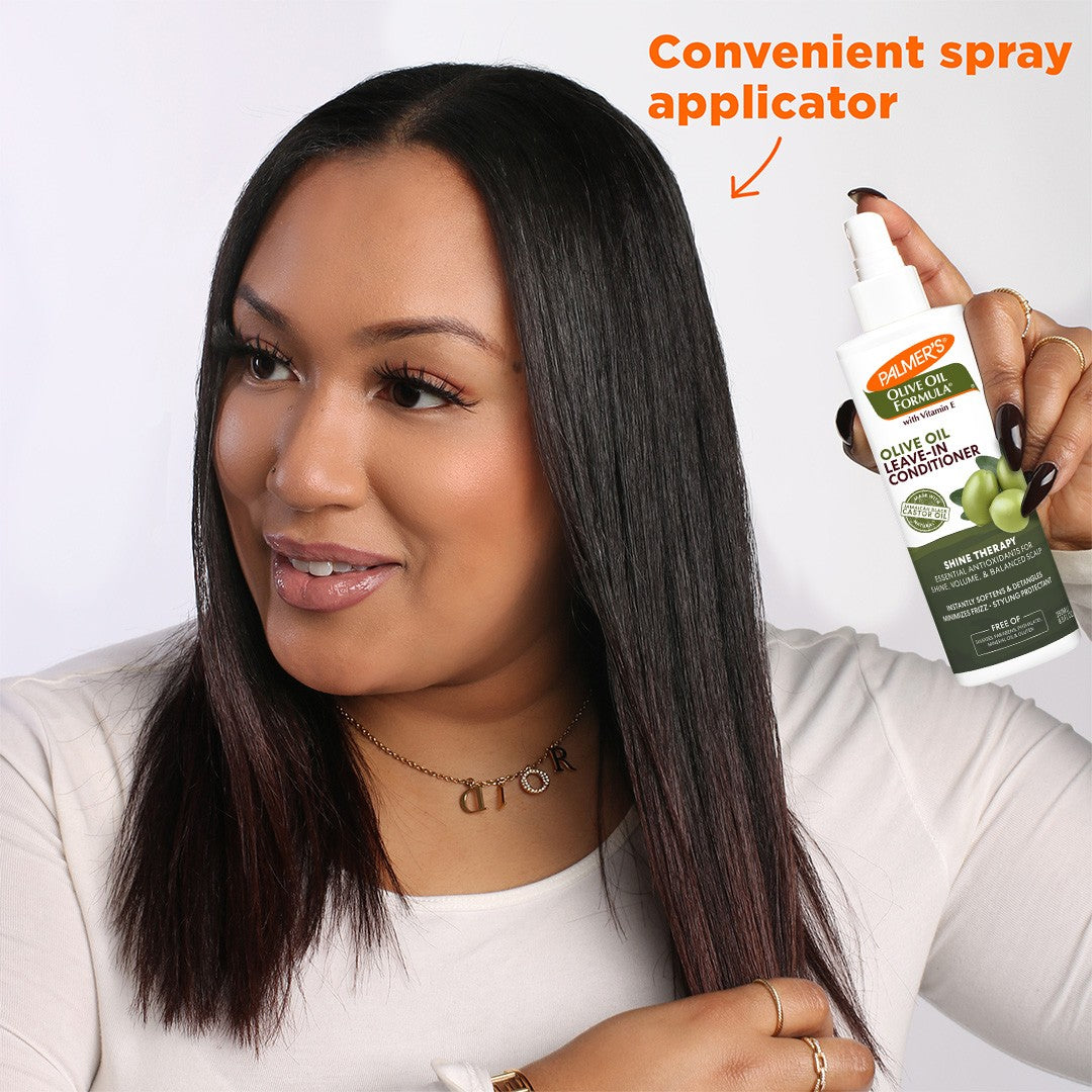Woman using Palmer’s Olive Oil Leave-In Conditioner spray.