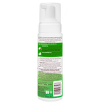 Bottle of hair care product with green label on a white background