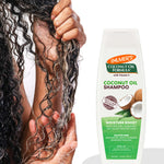 Coconut Oil Shampoo in use, boosting moisture on curly hair.