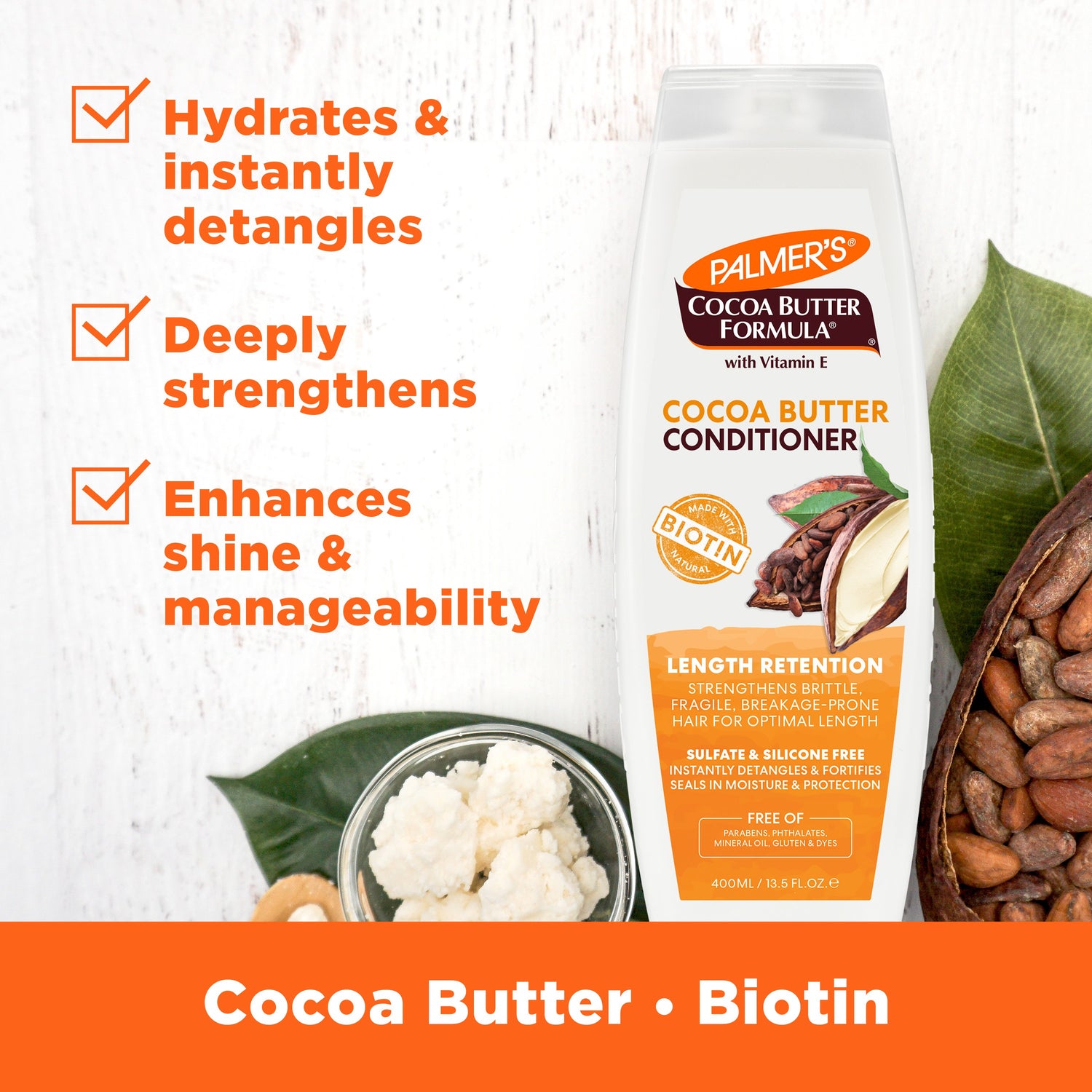 Cocoa Butter Conditioner bottle with cocoa beans and cocoa butter.