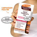 Palmer’s Skin Therapy Face Oil box held in hand.