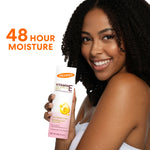 Woman holding Palmer’s Vitamin E Concentrated Cream, 48-hour moisture.