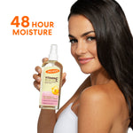 Woman holding Palmer’s Vitamin E Body Oil, 48-hour moisture.