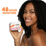 Woman holding Palmer's Vitamin E Body Butter, 48 Hour Moisture text visible.