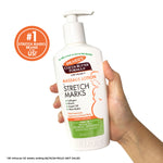 Cocoa Butter Massage Lotion for Pregnancy Stretch Marks in hand.