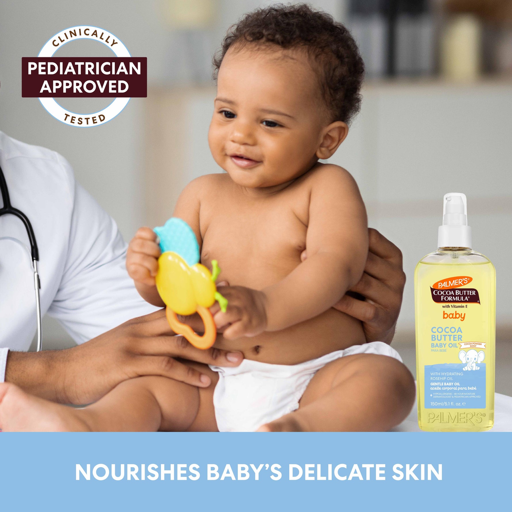 Baby with pediatrician, playing; Palmer’s Cocoa Butter Baby Oil bottle nearby.