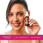 Woman holding a bottle of Palmer's Skin Therapy Face Oil with product features displayed below.