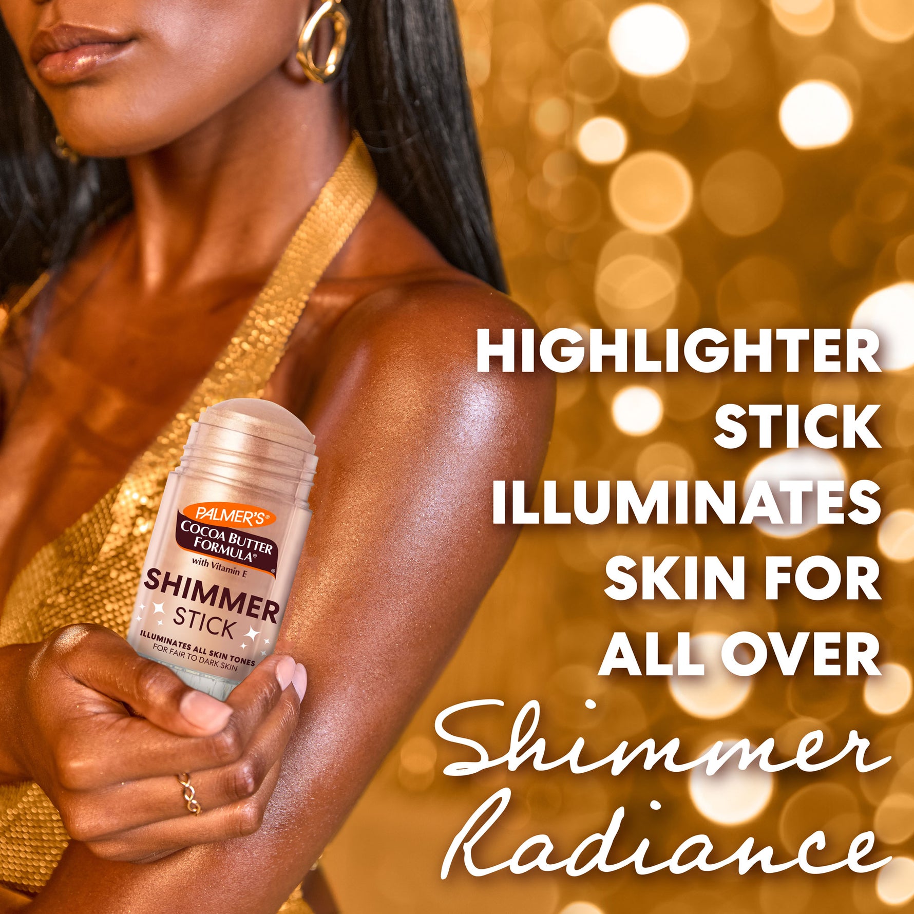 Woman holding a Palmer's Cocoa Butter Formula Shimmer Stick with a blurred gold background