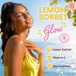 A woman in a yellow satin top stands outdoors by the ocean with her eyes closed, enjoying a sunny day. Large text reads 'LEMON SORBET' and 'Glow,' with smaller text listing 'Lemon Extract,' 'Vitamin C,' and 'Niacinamide.