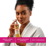 Woman holding a bottle of Palmer's Skin Therapy Cleansing Oil with text about approval and non-comedogenic properties.