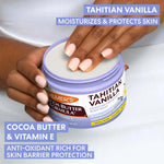 Palmer's Cocoa Butter Formula Tahitian Vanilla Body Balm with a hand holding it, on a white background.