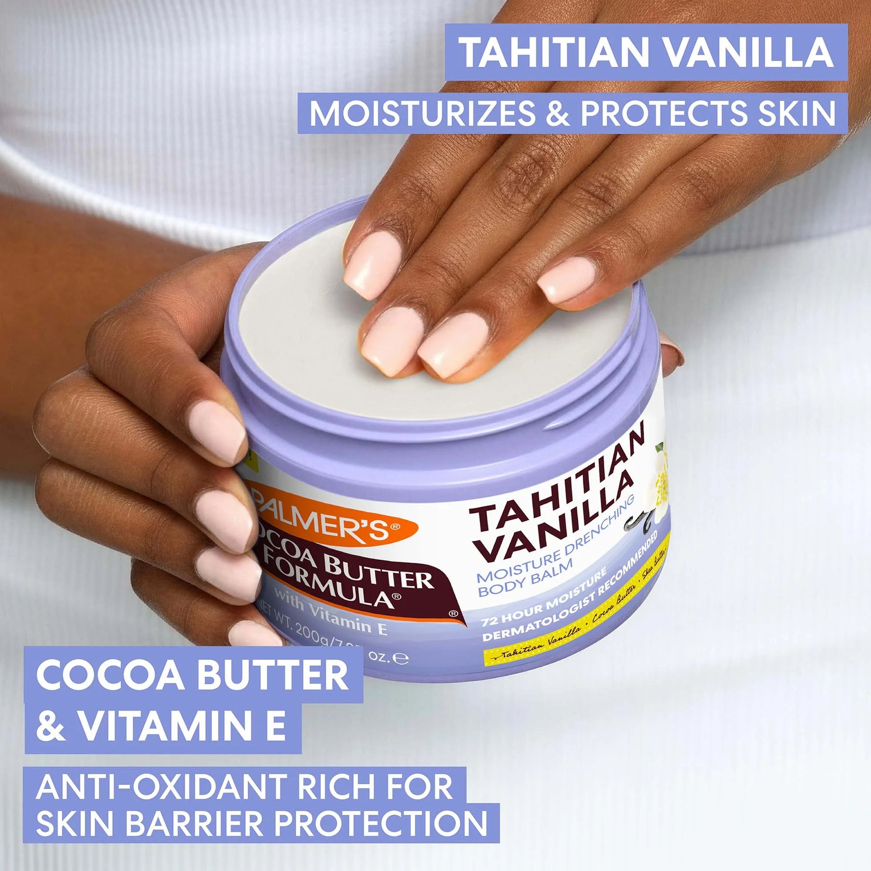 Palmer's Cocoa Butter Formula Tahitian Vanilla Body Balm with a hand holding it, on a white background.