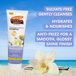 Palmer's Cocoa Butter Formula Tahitian Vanilla Shampoo tube with beach and flower background