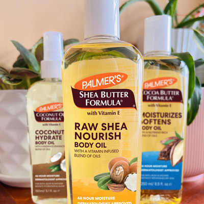 Palmer's Raw Shea Nourish Body Oil for glowing skin on vanity with Cocoa Butter and Coconut Oil Body Oils