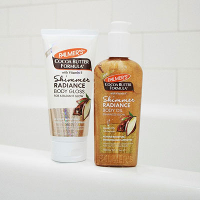 Palmer's Shimmer Radiance Body Gloss and Body Oil for holiday skin care on bath tub ledge