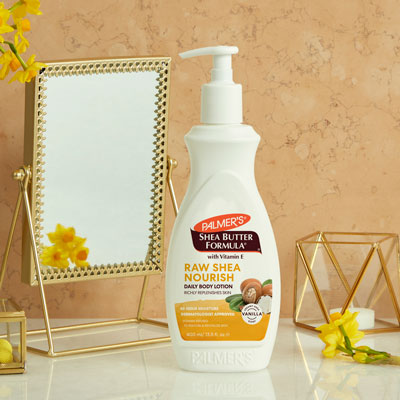 Palmer's Shea Butter for eczema-prone, sensitive skin on table with mirror and flowers